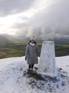 The summit of Murton Pike with views of the Eden Valley in background